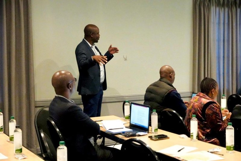 Standing: Mr Masvora Director at the Department of Communications, Ministry of local Government-Zimbabwe explaining how disaster information is cascaded to the last mile